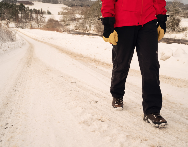 Man walking through snowy countryside