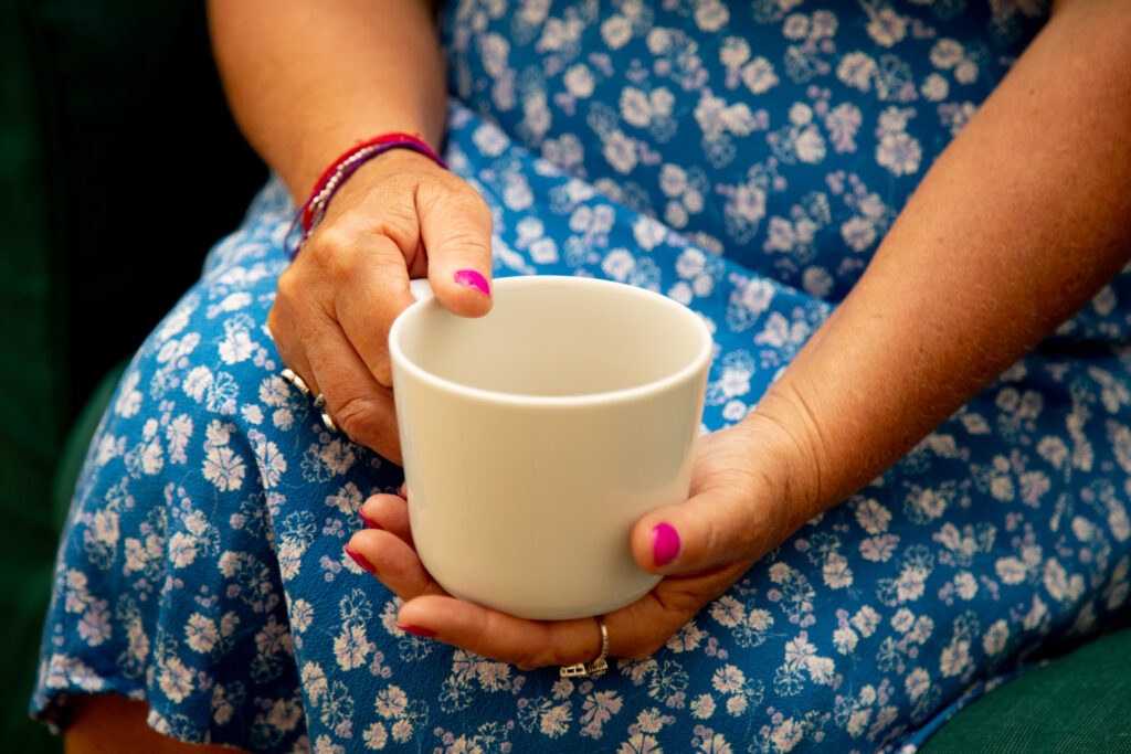 A stock image showing a woman with a cup of tea